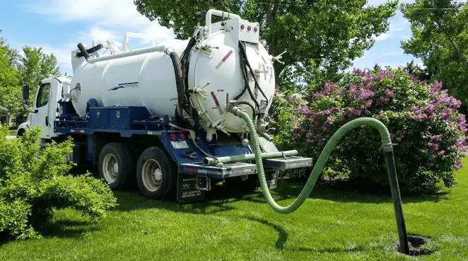 Professional vacuum truck performing residential drainage and septic maintenance in Baton Rouge, LA