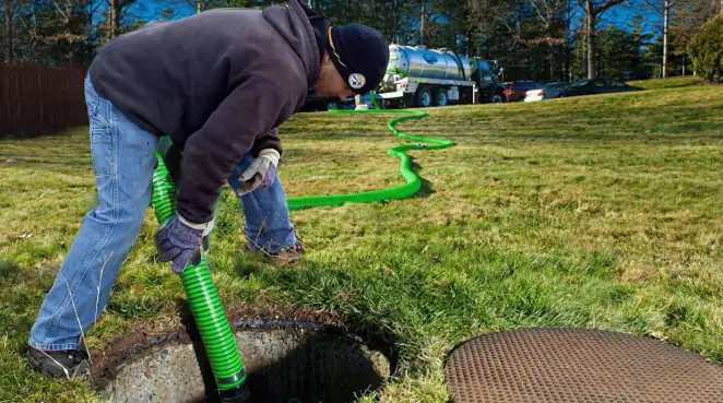 Service technician performing residential septic pumping and drainage maintenance in Baton Rouge, LA